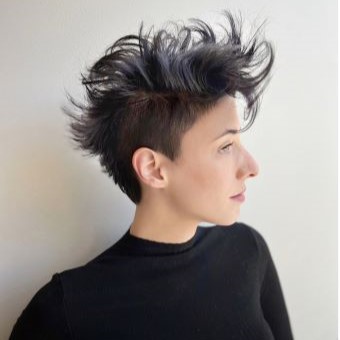 Side profile of an undercut pixie haircut styled with volume on top.